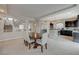 Bright and airy dining area connects seamlessly to a modern kitchen and staircase, perfect for entertaining at 9835 Fox Estate St, Las Vegas, NV 89141