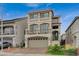 Contemporary three-story home featuring a two-car garage at 9835 Fox Estate St, Las Vegas, NV 89141