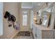 Welcoming foyer with coat rack and an ornate cabinet at 9835 Fox Estate St, Las Vegas, NV 89141