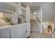 Inviting foyer with decorative cabinet and staircase leading to the upper level at 9835 Fox Estate St, Las Vegas, NV 89141