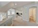 Open-concept hallway with neutral tones leads to a bathroom and living area at 9835 Fox Estate St, Las Vegas, NV 89141