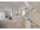 Bright hallway featuring an open dining area and a modern staircase with glass railing at 9835 Fox Estate St, Las Vegas, NV 89141