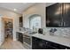 A kitchen with modern appliances, dark wood cabinets and a pantry to the left at 9835 Fox Estate St, Las Vegas, NV 89141
