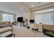 Comfortable living area featuring a large TV, a workspace, and abundant natural light at 9835 Fox Estate St, Las Vegas, NV 89141