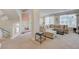 Bright, open living room with a sectional sofa and staircase at 9835 Fox Estate St, Las Vegas, NV 89141