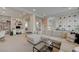 Living room features an open layout with a workspace, a bookshelf, and stairs in view at 9835 Fox Estate St, Las Vegas, NV 89141