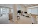 Spacious living room with a plush sofa, a workspace, and a balcony entrance at 9835 Fox Estate St, Las Vegas, NV 89141