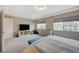 Bright main bedroom with large windows, carpet flooring, and a modern entertainment center at 9835 Fox Estate St, Las Vegas, NV 89141
