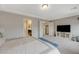 Spacious main bedroom with a TV, carpet flooring, and ensuite bathroom access at 9835 Fox Estate St, Las Vegas, NV 89141