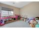 Spacious playroom features toys, ample storage, and a bright window at 9835 Fox Estate St, Las Vegas, NV 89141
