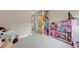 This playroom is filled with toys, storage solutions, and a whimsical dollhouse at 9835 Fox Estate St, Las Vegas, NV 89141