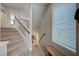 Carpeted staircase with glass railing and a window at 9835 Fox Estate St, Las Vegas, NV 89141