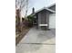 Exterior of home with a white garage door, a stacked stone facade, and a long driveway at , Las Vegas, NV 89110