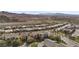 Aerial view of home in desert community showcasing nearby mountain and golf course at 13 Scenic Terrain Ave, Henderson, NV 89011