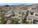 Aerial view of backyard showcasing a putting green, patio with fire pit and swimming pool at 13 Scenic Terrain Ave, Henderson, NV 89011