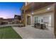 An outdoor dining area with a full kitchen, putting green, and large format pavers at 13 Scenic Terrain Ave, Henderson, NV 89011