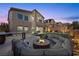 A luxurious outdoor living area features a fire pit, kitchen, and putting green at 13 Scenic Terrain Ave, Henderson, NV 89011