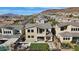 Home featuring a backyard with a putting green, patio with fire pit and table with chairs at 13 Scenic Terrain Ave, Henderson, NV 89011