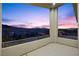 A spacious balcony with a view of the sunset over mountains at 13 Scenic Terrain Ave, Henderson, NV 89011