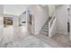 Bright and airy entryway featuring modern staircase, tile flooring, and seamless access to the living area at 13 Scenic Terrain Ave, Henderson, NV 89011