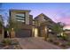Modern two-story home featuring a two-car garage, desert landscaping, and a paved driveway at 13 Scenic Terrain Ave, Henderson, NV 89011