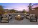 A stone fire pit and lounge seating offer a relaxing outdoor gathering spot at 13 Scenic Terrain Ave, Henderson, NV 89011