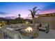 A conversation fire pit, surrounded by cushioned seating, offers a comfortable outdoor space at 13 Scenic Terrain Ave, Henderson, NV 89011