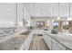 Bright kitchen features white cabinets, granite countertops, stainless steel appliances, and a tile backsplash at 13 Scenic Terrain Ave, Henderson, NV 89011