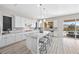 Spacious kitchen featuring an island with seating, granite counters, and sliding glass doors to the patio at 13 Scenic Terrain Ave, Henderson, NV 89011