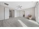 Bright primary bedroom with ceiling fan, sitting area, and access to a private bathroom at 13 Scenic Terrain Ave, Henderson, NV 89011