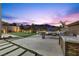 A backyard featuring a putting green, fire pit, and outdoor kitchen area at 13 Scenic Terrain Ave, Henderson, NV 89011