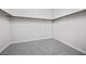 Bright walk-in closet with neutral carpeting and shelving at 13 Scenic Terrain Ave, Henderson, NV 89011
