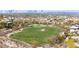 An aerial view showcases a lush golf course with mature trees in a picturesque community at 1455 Macdonald Ranch Dr, Henderson, NV 89012