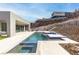 Luxury backyard pool includes a spa, outdoor kitchen, and a hillside view for ultimate relaxation at 1455 Macdonald Ranch Dr, Henderson, NV 89012