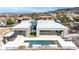 Contemporary home with a backyard pool, outdoor kitchen, and lush, modern landscaping at 1455 Macdonald Ranch Dr, Henderson, NV 89012