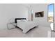 A modern bedroom featuring a comfortable bed, mirrored nightstands, and an artful accent wall at 1455 Macdonald Ranch Dr, Henderson, NV 89012