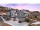 Modern home with clean lines, multi-car garage and native landscape ascends hillside at 1455 Macdonald Ranch Dr, Henderson, NV 89012