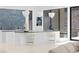 Open-concept kitchen featuring marble floors, white counters, and modern lighting fixtures at 1455 Macdonald Ranch Dr, Henderson, NV 89012