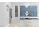 Close-up of a modern kitchen with an island, and stylish blue backsplash, and white cabinetry at 1455 Macdonald Ranch Dr, Henderson, NV 89012