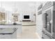 Modern kitchen featuring white cabinets, stainless steel appliances, and decorative pendant lighting at 1455 Macdonald Ranch Dr, Henderson, NV 89012