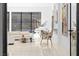 Living room with floor-to-ceiling windows, modern white furniture, a white piano, and modern art at 1455 Macdonald Ranch Dr, Henderson, NV 89012