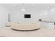 Bright living room with sleek lighting, a stylish curved sofa, and a modern bar area at 1455 Macdonald Ranch Dr, Henderson, NV 89012
