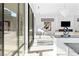 Spacious living room with floor-to-ceiling windows, a white piano, and a modern fireplace at 1455 Macdonald Ranch Dr, Henderson, NV 89012