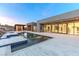 Backyard with luxury pool, covered outdoor kitchen and large doors open to home's interior living areas at 1455 Macdonald Ranch Dr, Henderson, NV 89012
