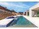 A stunning pool with blue tile and stone deck provides a serene oasis in this backyard retreat at 1455 Macdonald Ranch Dr, Henderson, NV 89012