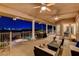 Backyard oasis featuring a covered patio, pool, hot tub, and city views at twilight at 1700 Brock Ct, Las Vegas, NV 89117