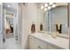 Bright bathroom featuring a white vanity, neutral walls, tile flooring and doorway to an office at 1700 Brock Ct, Las Vegas, NV 89117
