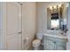 Neutral toned powder room featuring a white toilet and vanity with stone countertop at 1700 Brock Ct, Las Vegas, NV 89117