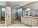 An elegant bathroom showcases a glass shower, dual vanities, marble countertops and flooring at 1700 Brock Ct, Las Vegas, NV 89117