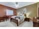 Cozy bedroom with a dark wood bed frame, white bedding, and a window with shutters at 1700 Brock Ct, Las Vegas, NV 89117